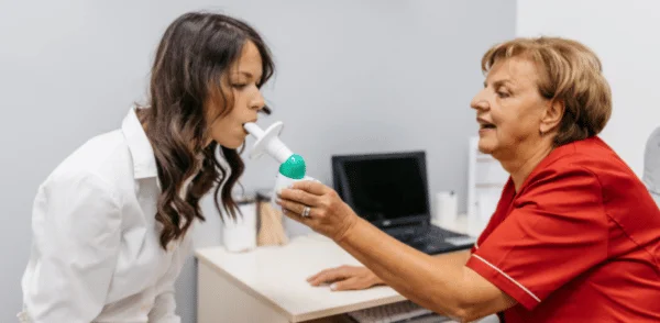 A woman getting a Peak Flow Meter test