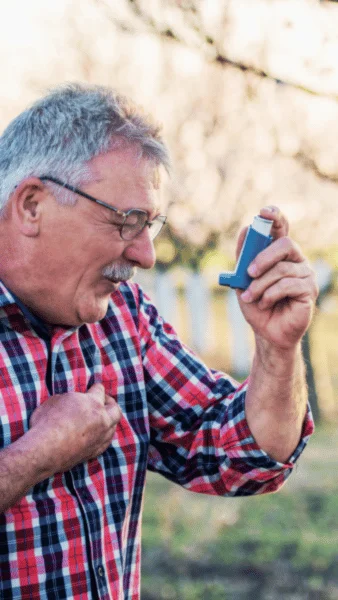 Man feeling fine after using asthma inhaler