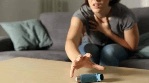 woman trying to reach asthma inhaler