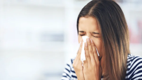 Girl sneezing due to hay fever