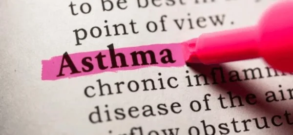 Pen highlighting the word 'Asthma' in pink for emphasis on the condition